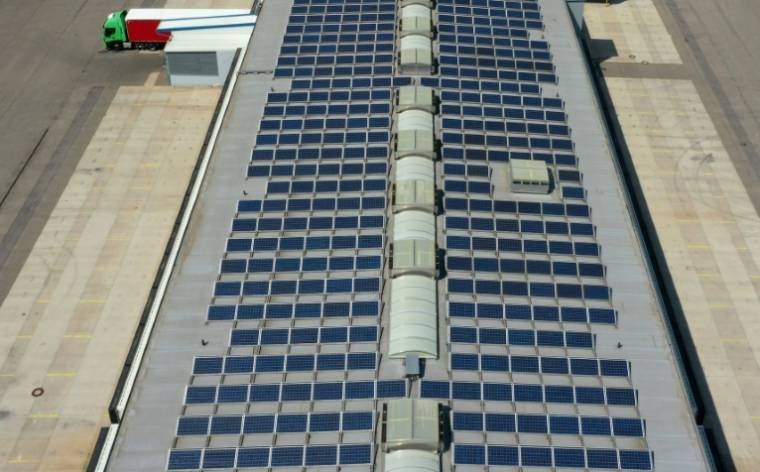 The photo was taken with a drone showing solar panels on the roof of a carrier's aircraft hangar, August 2, 2022 in Aurach (Germany) (AFP/Christof STACHE)